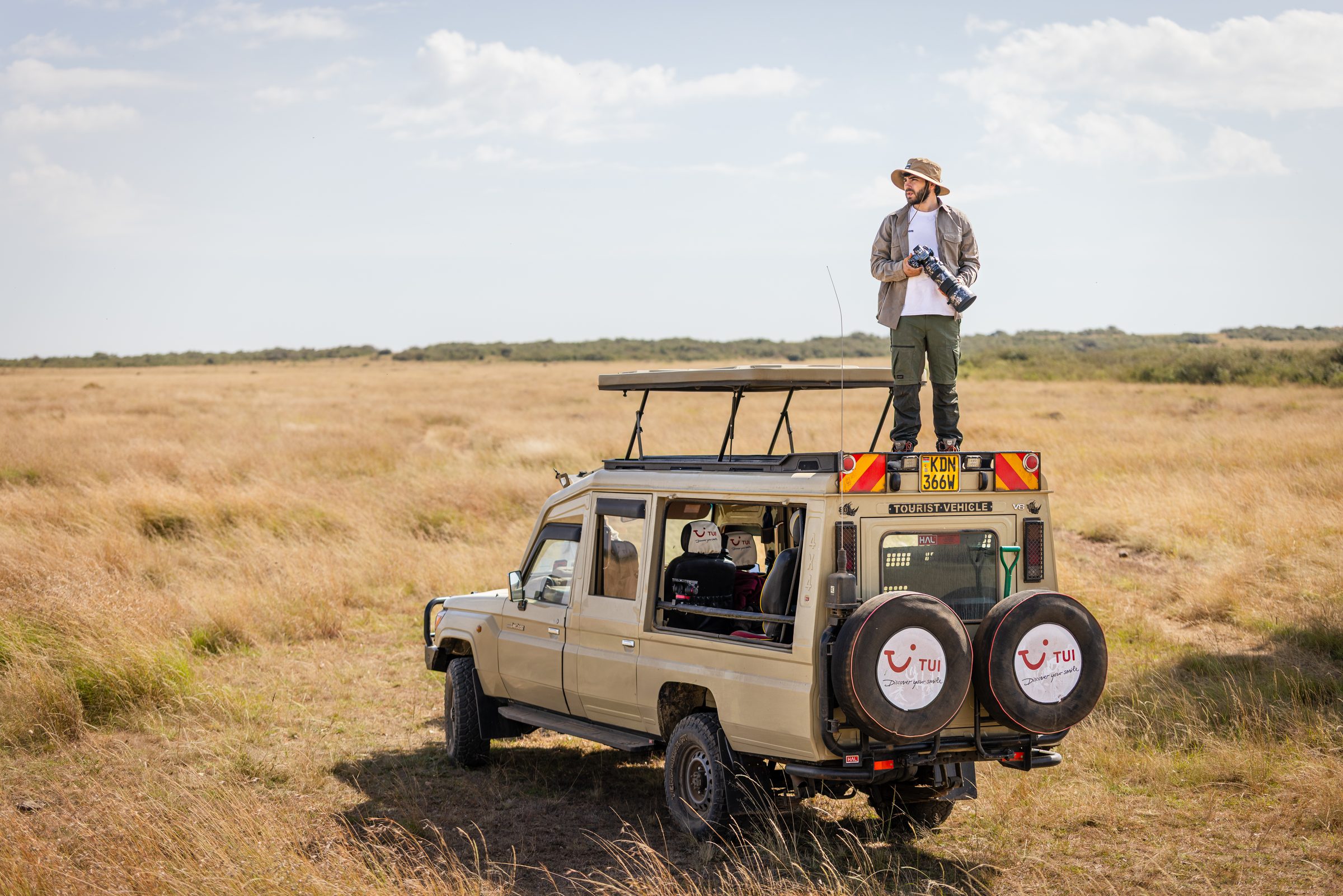 Greg sobre un todoterreno de safari en la sabana